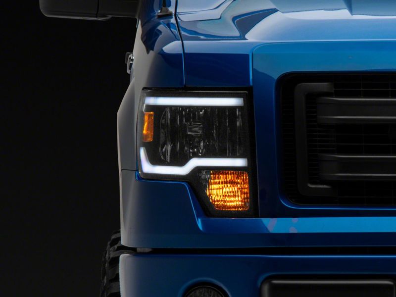 Raxiom 09-14 Ford F-150 Axial Series Headlight w/ SEQL LED Bar- Black Housing (Clear Lens)